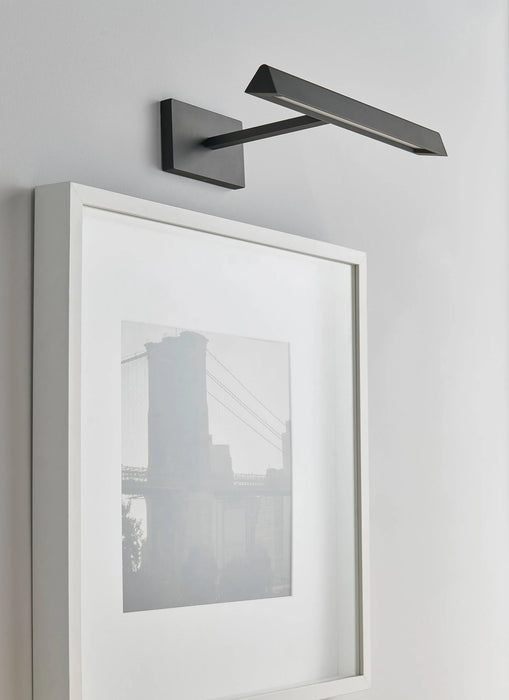 A rectangular black outdoor wall light with a textured finish casting light downwards.