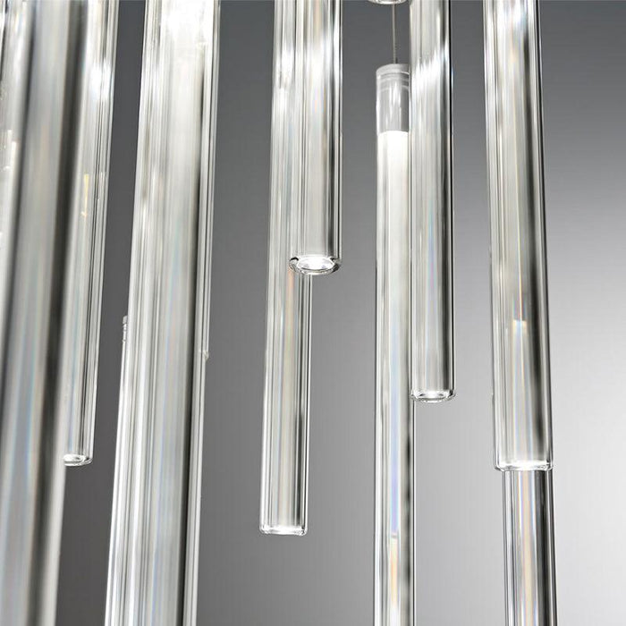 Large, modern pendant light with a cylindrical, metallic shade, angled view.