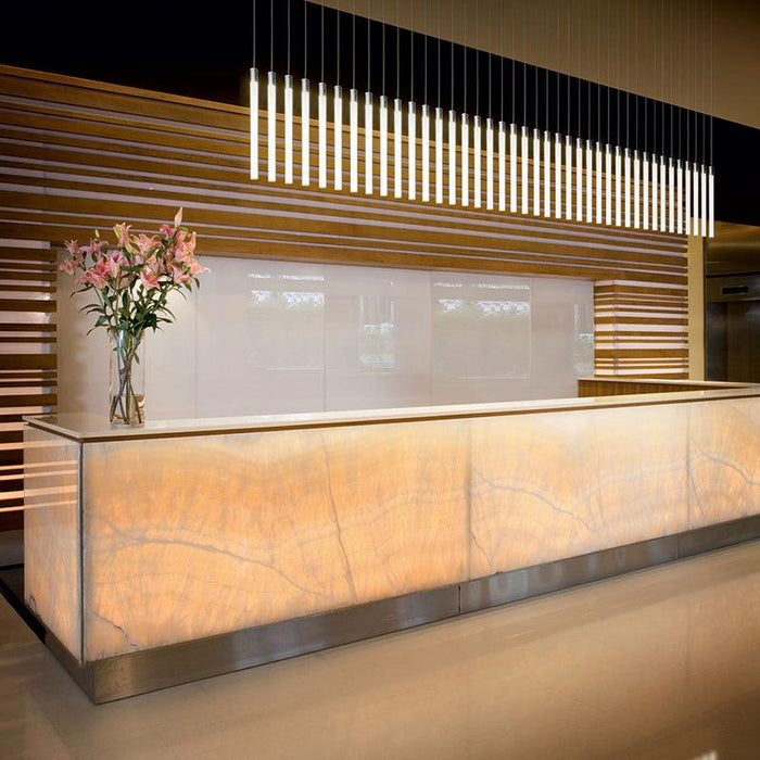Large, modern pendant light with a cylindrical, metallic shade, close-up of shade.