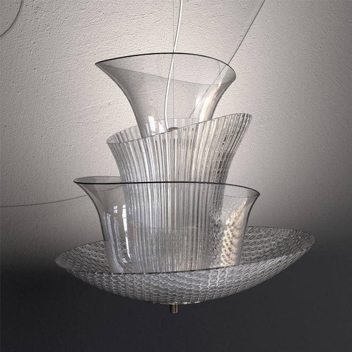 Large, modern wall sconce with a rectangular, textured glass panel, illuminated.