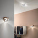 Large, modern wall sconce with a rectangular, metallic frame and three light bars.