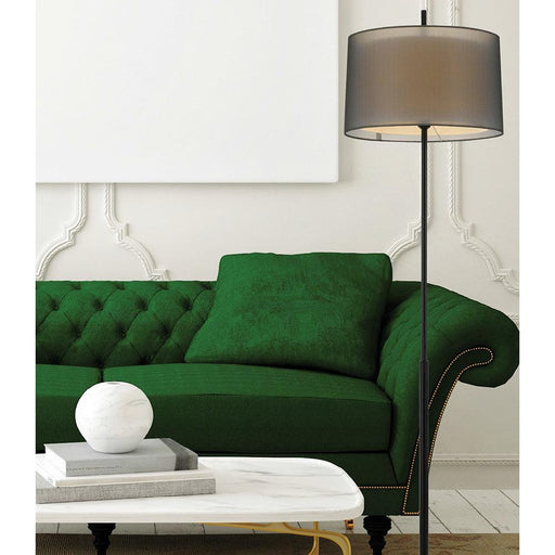 Black floor lamp with a conical fabric shade, illuminated.