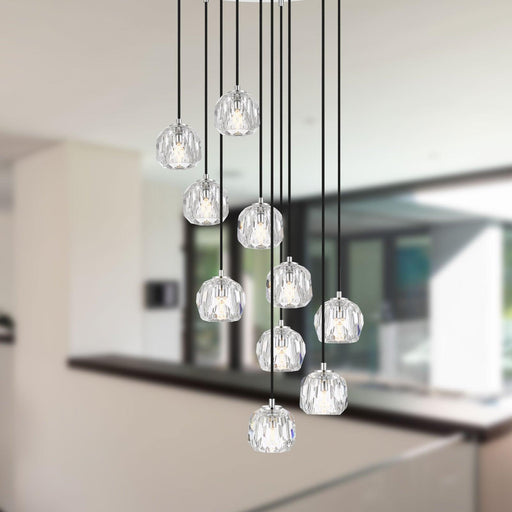 Chrome pendant light with a curved design, illuminated.