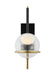 A modern black and brass wall sconce with a cylindrical shade mounted on a light wall.