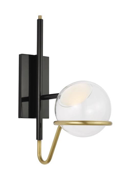 A modern wall sconce with a black cylindrical shade and a brass accent.