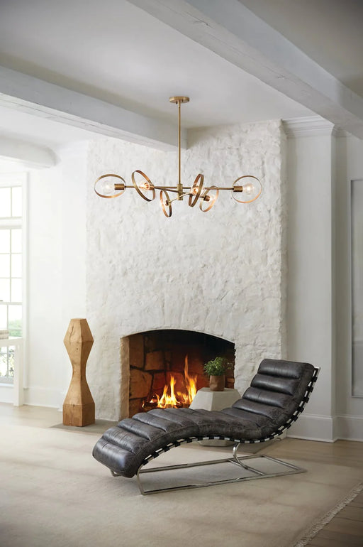 Lacquered brass and clear glass five-light linear chandelier with bell-shaped shades, angled view.