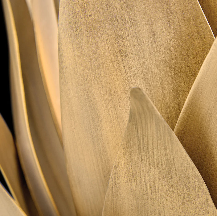 A close-up of a textured gold and black abstract wall art piece.