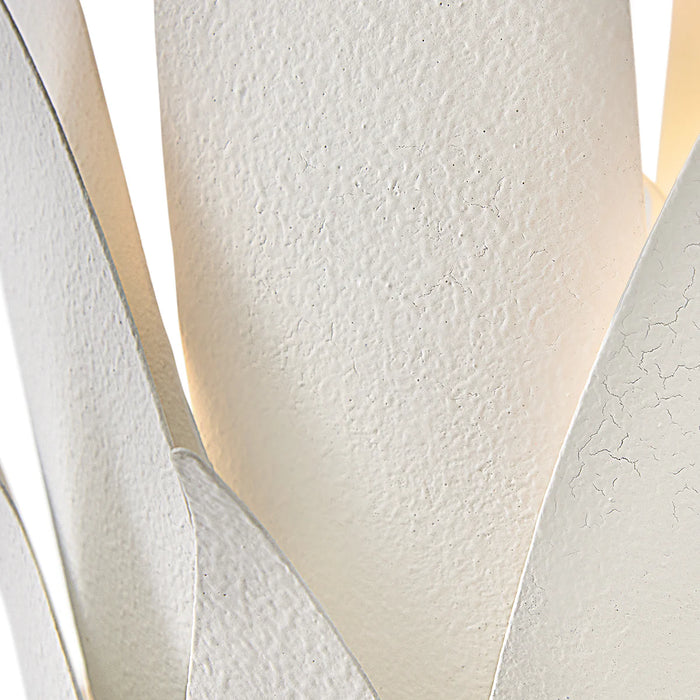 A close-up of a textured silver and black abstract wall art piece.