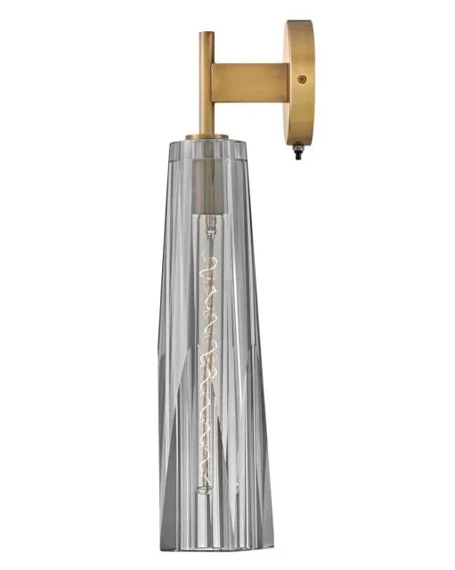An angled view of a modern semi-flush mount light with a clear glass globe and a dark bronze finish.