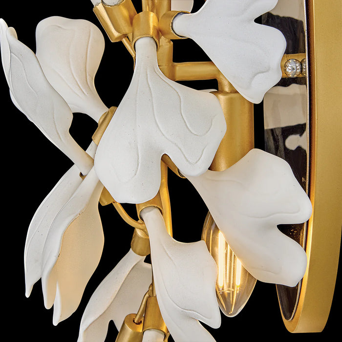 A close-up of a circular abstract wall art piece with gold and black textures.